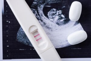 close up of pills and pregnancy test on ultrasound image