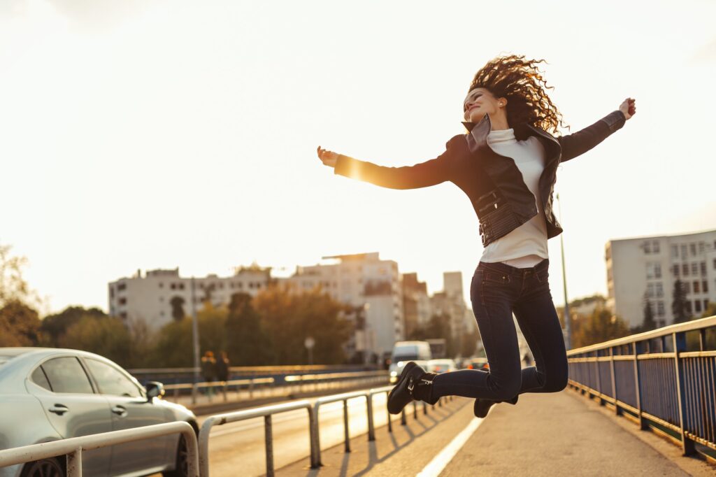 Happiness and energetic fresh portrait of young woman excited jumping up